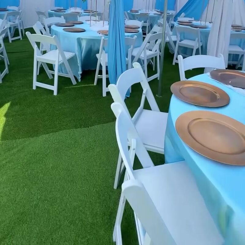 Blue linens and white chairs under blue and white draping